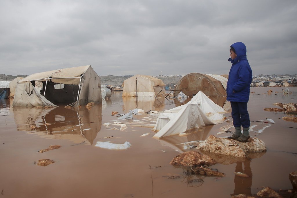 A child looks over a flooded area at an IDP camp in northwestern Syria. (file photo)